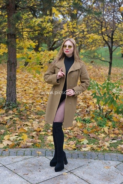 Stylish Young Woman in Long Boots & Coat Outfit at Autumn Park