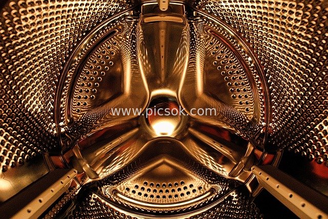 Close-up of Washing Machine Drum Interior | Metallic Textured Cleaning Appliance Background Image