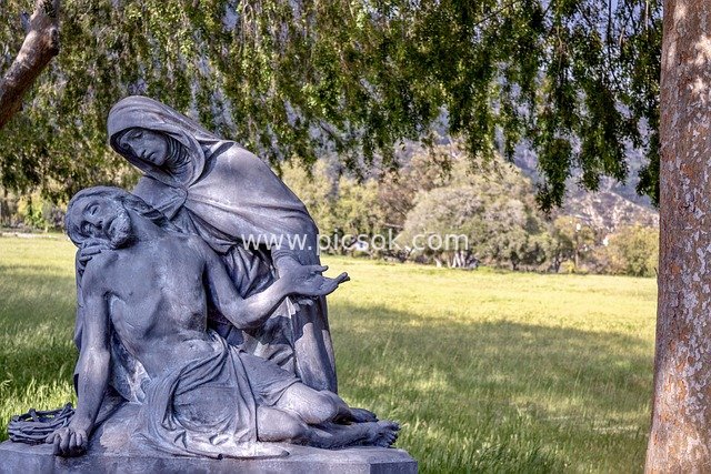 Religious Statue of Virgin Mary Mourning Jesus on an Outdoor Lawn