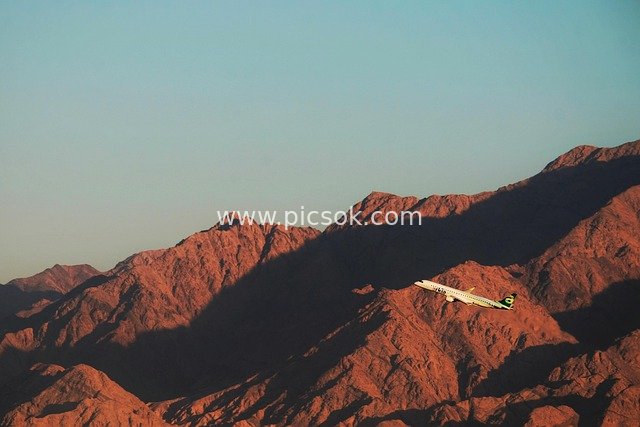 Airplane Flying Over Red Rock Desert Mountains in Eilat - Travel Scene