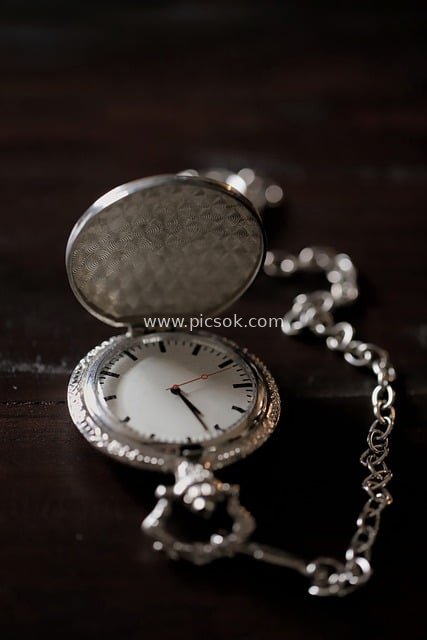 Close-Up of Vintage Silver Pocket Watch Showcasing Exquisite Time Hands Details