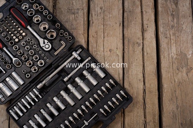 Professional Hardware Tool Set with Ratchet Wrench, Socket, and Bit (Wooden Background)