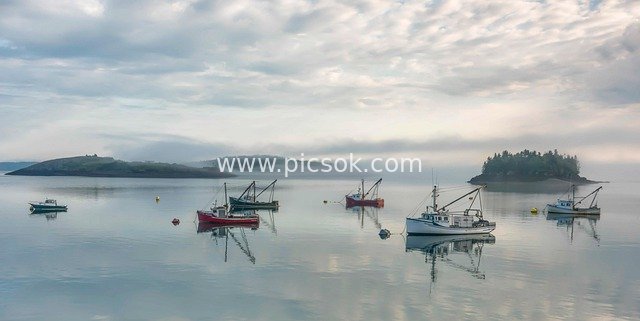 Commercial Fishing Boats and Island Reflections on Calm Morning Seas in Maine