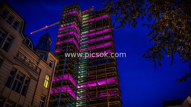 Night Construction Site: High-Rise Under Construction with Colorful Lights