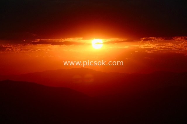 Magnificent Sunset Among Layered Mountains: Breathtaking Orange-Red Sky and Cloud Sea