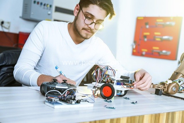 Scene of a Young Engineer Focused on Electronic Repair in the Laboratory
