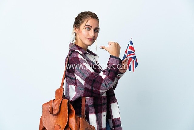 Confident Female Student Holding British Flag Exudes Youthful Vitality