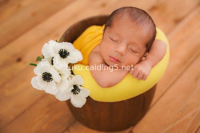 Sleeping Newborn Photography | Warm Yellow Swaddled Baby Portrait