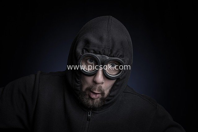 Creative Material of a Man in Black with Goggles Making Funny Expressions